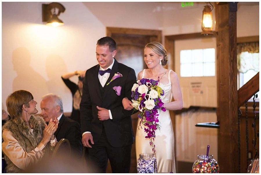 bride and groom entrance at Deer Creek Valley Ranch wedding by Estes Park wedding photographer Jennie Crate