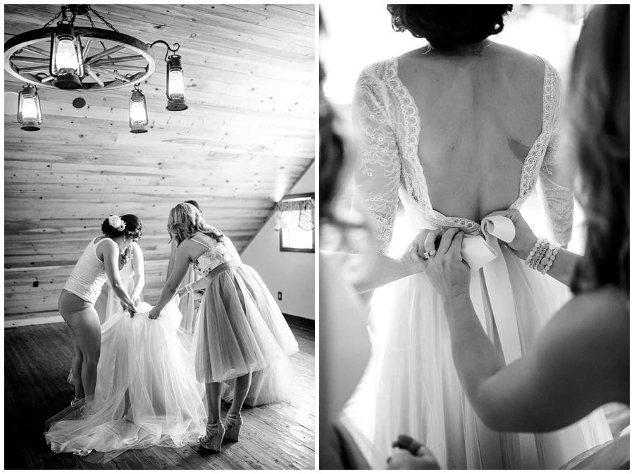 bride getting dressed in loft in barn at Deer Creek Valley Ranch wedding by Denver wedding photographer Jennie Crate