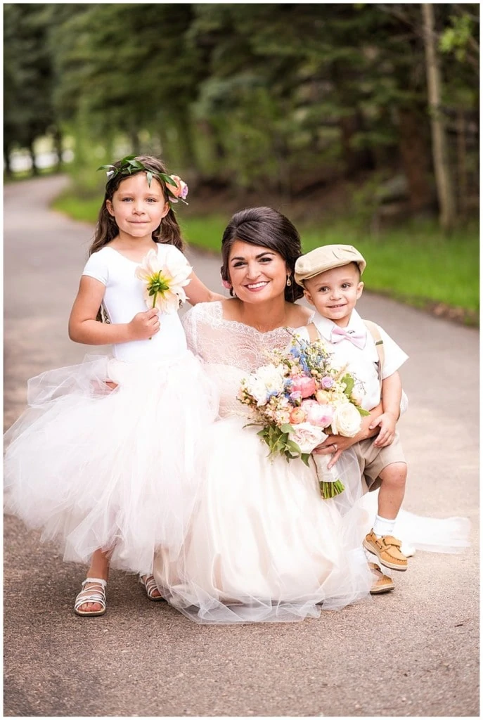bride with flower girl and ring bearer at Deer Creek Valley Ranch wedding by Boulder wedding photographer Jennie Crate
