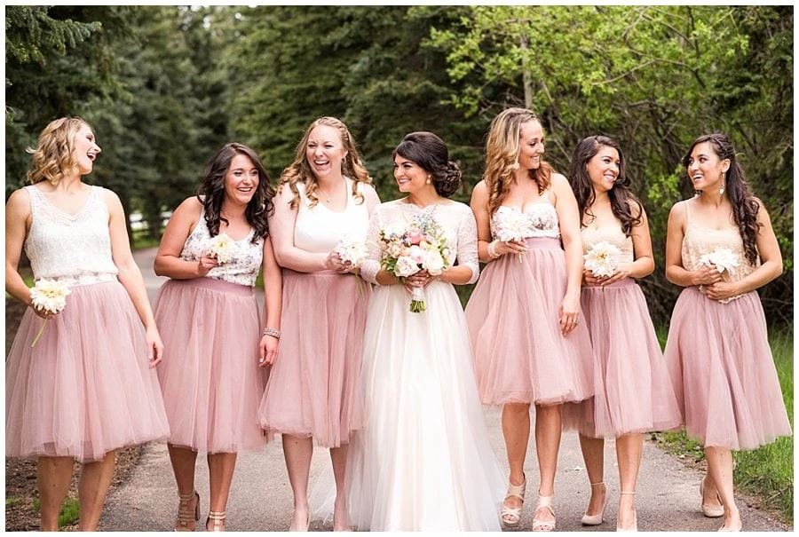bridesmaids in blush pink tulle skirts and mismatched tops at Deer Creek Valley Ranch wedding by Boulder wedding photographer Jennie Crate