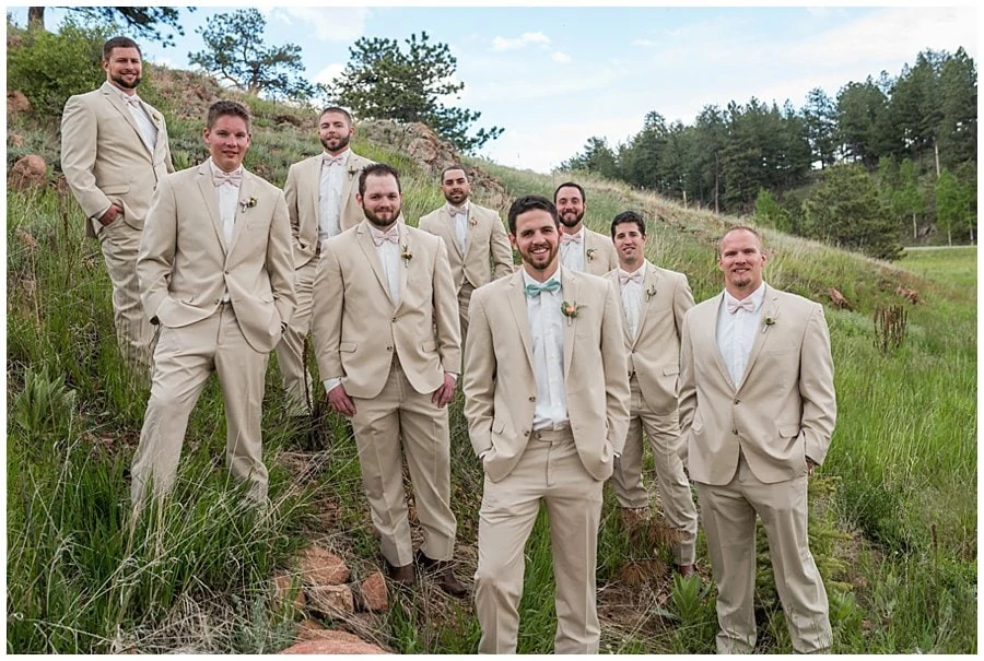 groom and groomsmen in khaki suits and bowties at Deer Creek Valley Ranch wedding by Denver wedding photographer Jennie Crate