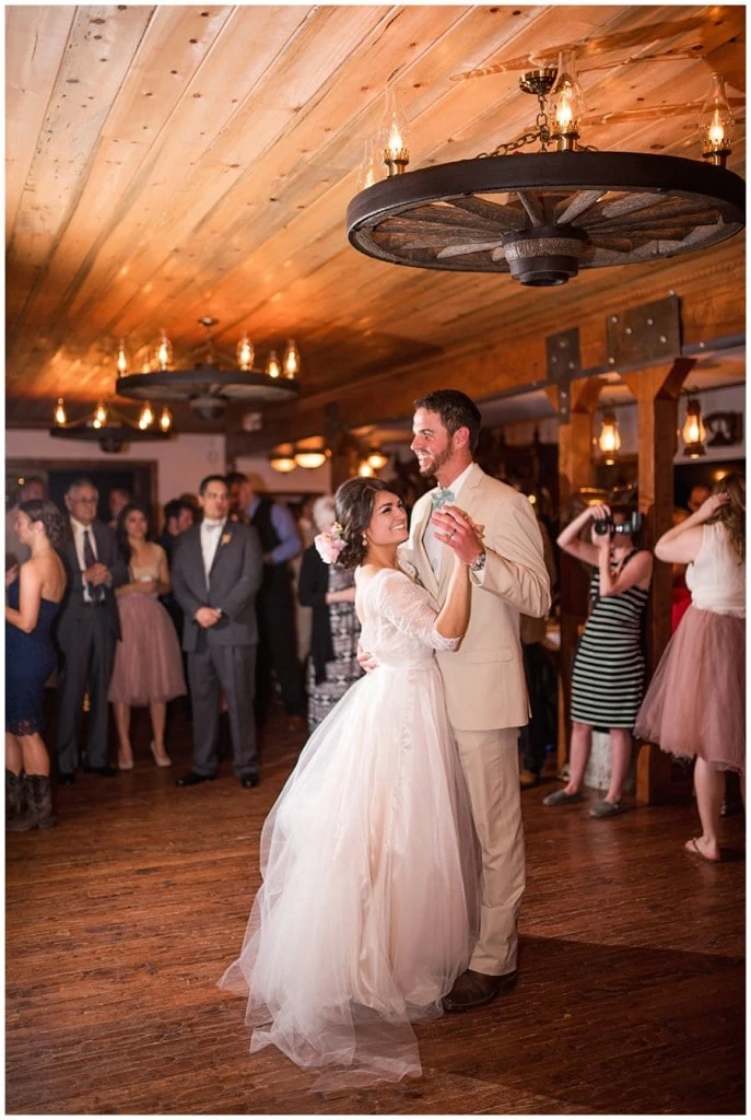 bride and groom first dance in barn at Deer Creek Valley Ranch wedding by Deer Creek Valley Ranch wedding photographer Jennie Crate