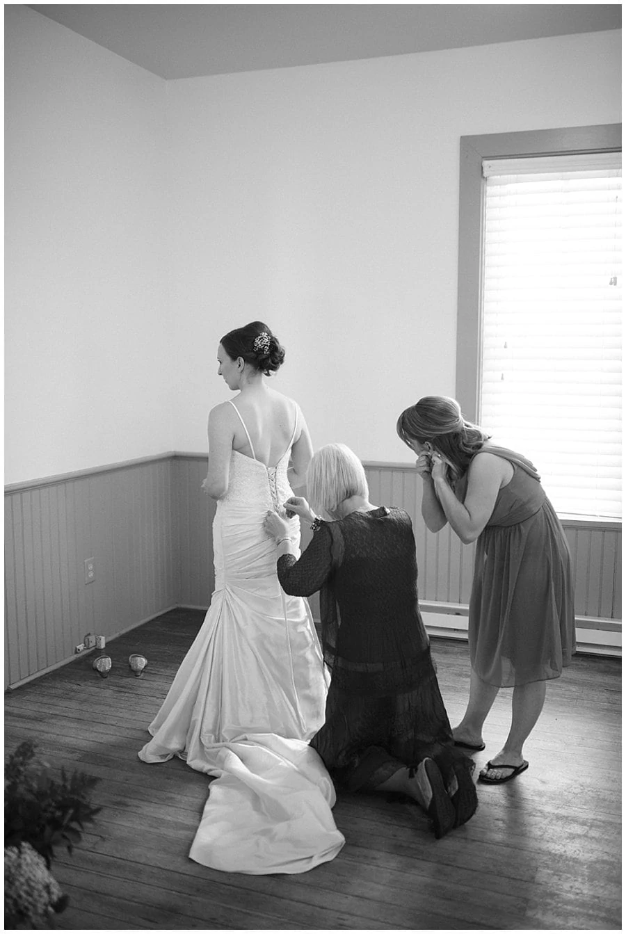 bride getting wedding dress laced up in school house at spring Denver Botanic Gardens at Chatfield Wedding by Denver wedding photographer Jennie Crate