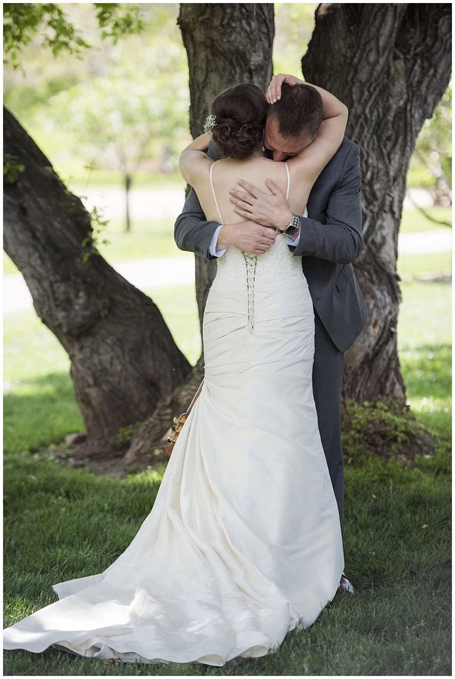 bride and groom embrace after first look at spring Denver Botanic Gardens at Chatfield Wedding by Boulder wedding photographer Jennie Crate