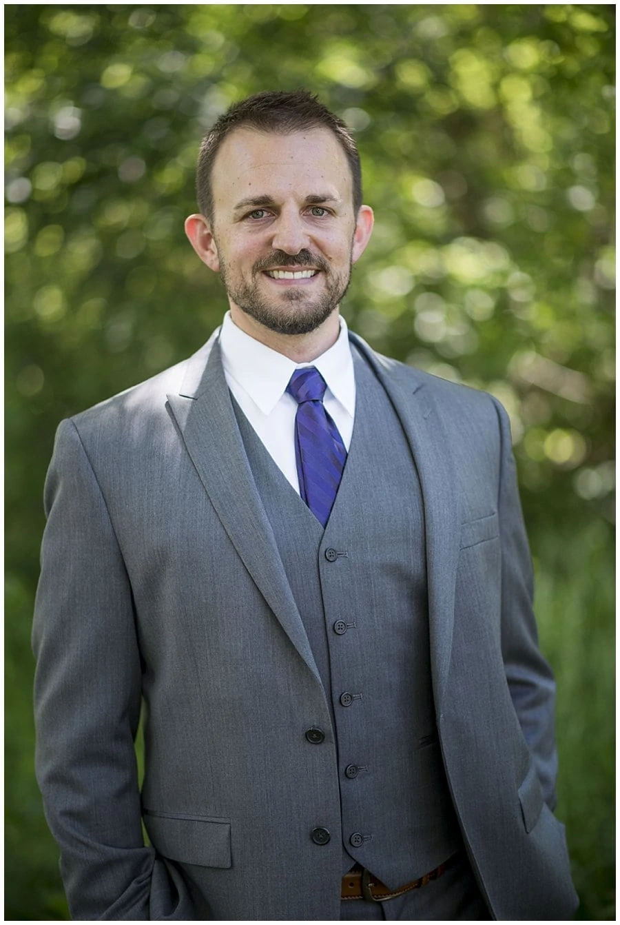 groom in grey suit and purple tie at spring Denver Botanic Gardens at Chatfield Wedding by Boulder wedding photographer Jennie Crate