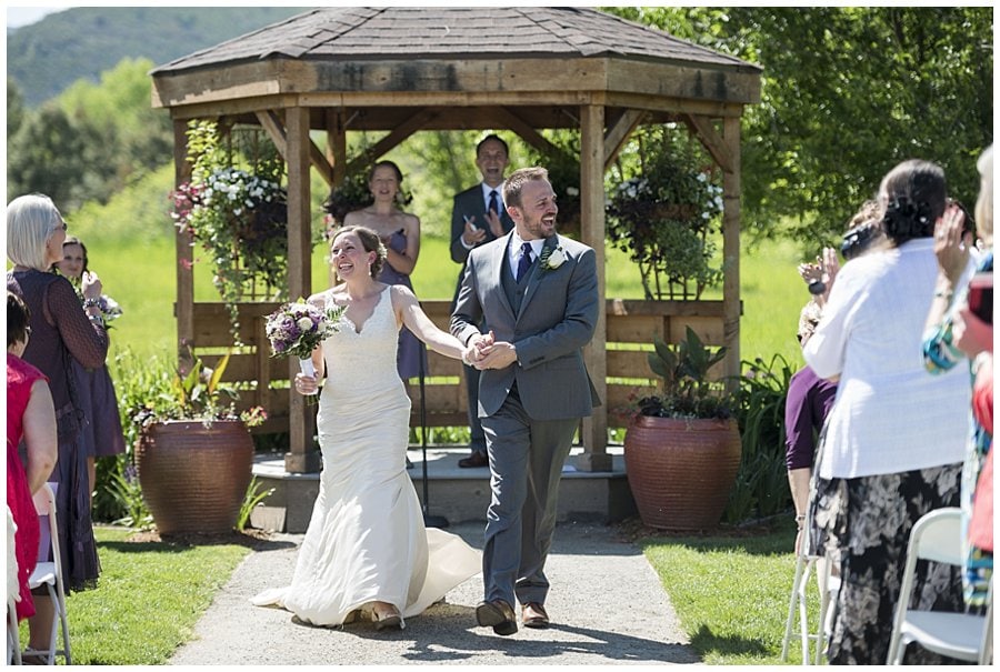 bride and groom walk back down aisle of open air chapel at spring Denver Botanic Gardens at Chatfield Wedding by Denver Botanic Gardens wedding photographer Jennie Crate