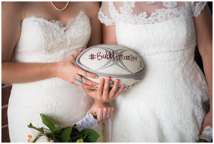 LGBT wedding with two brides and rugby ball photo