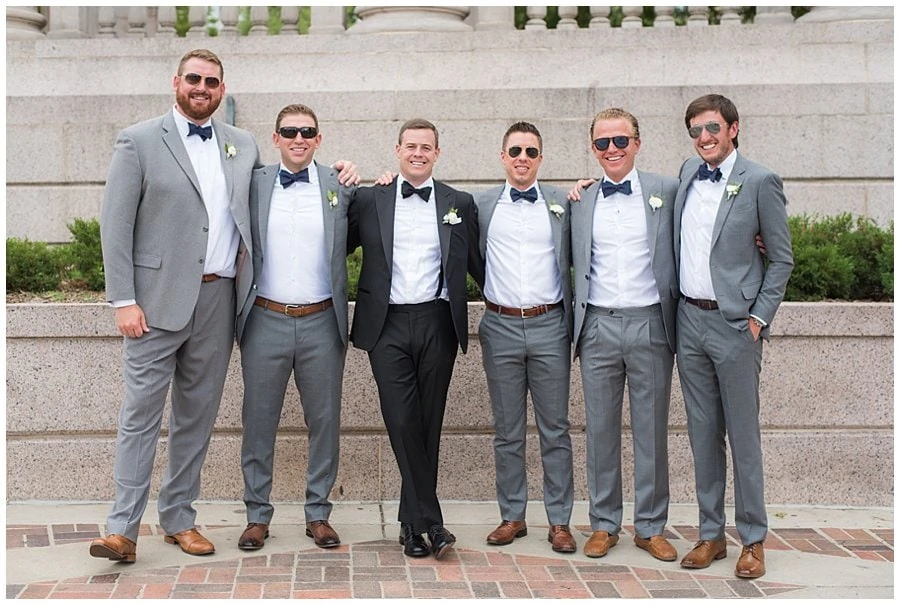 groom and groomsmen in grey suits with bow ties at civic center part before blanc Denver wedding by Boulder Wedding Photographer Jennie Crate Photographer