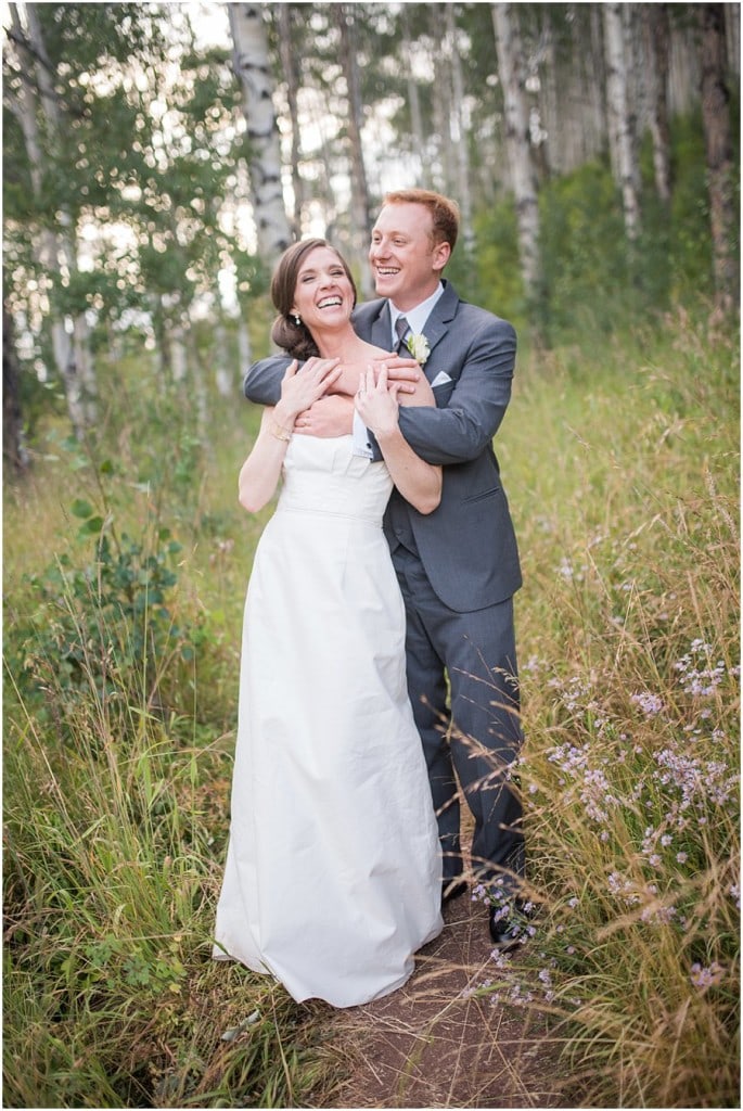bride and groom in Piney Colorado aspen trees at Piney River Ranch wedding by Colorado Wedding photographer Jennie Crate, Photographer