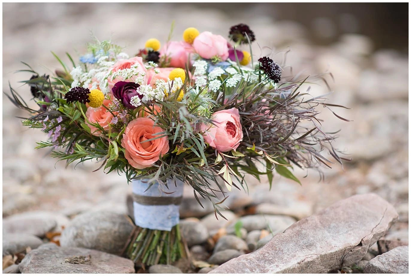 Love Letter Floral bridal bouquet on river rocks at Lyons Riverbend wedding by Lyons wedding photographer Jennie Crate