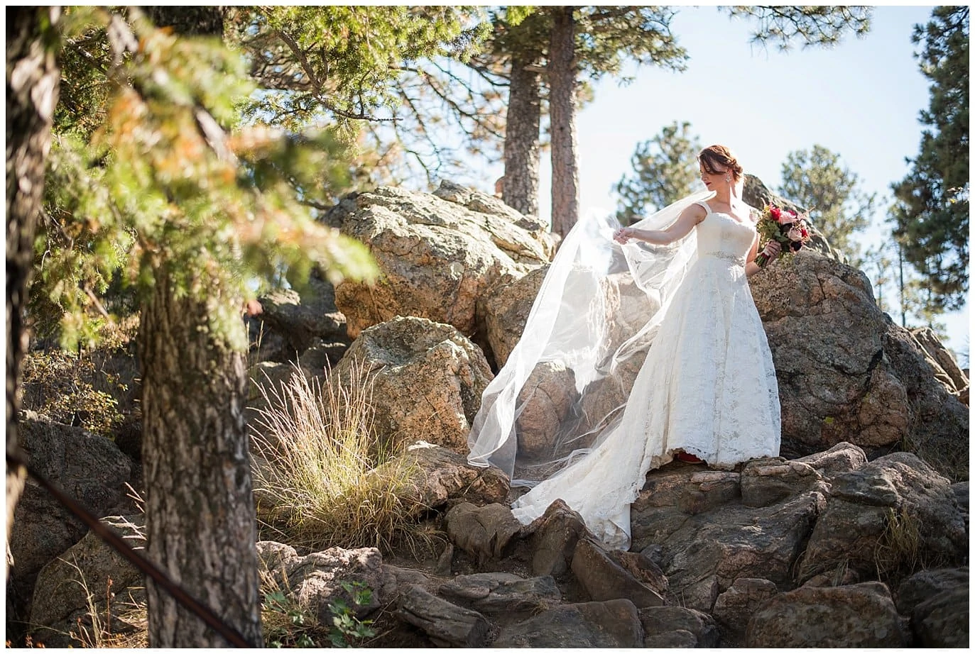 bride on rocks at Lookout Mountain Mansion wedding by Golden wedding photographer Jennie Crate