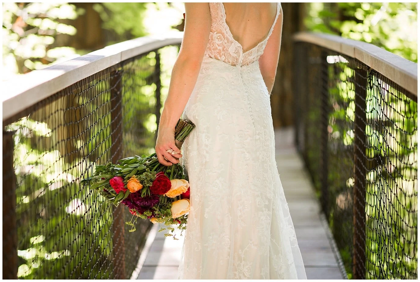 bride in lacebacked dress on washington treehouse bridge