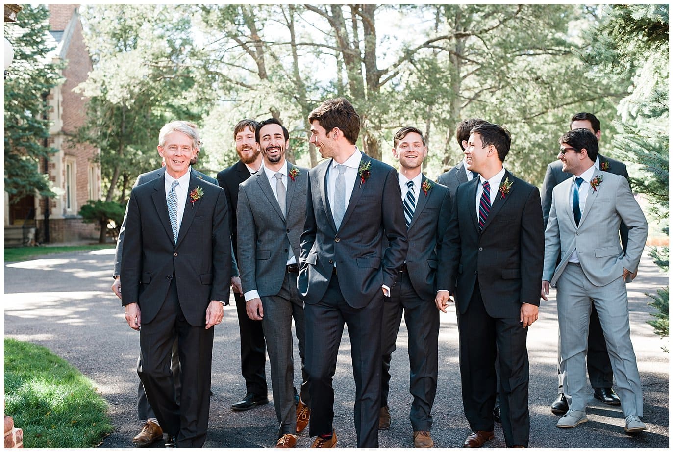 groomsmen in mismatched black and gray suits photo