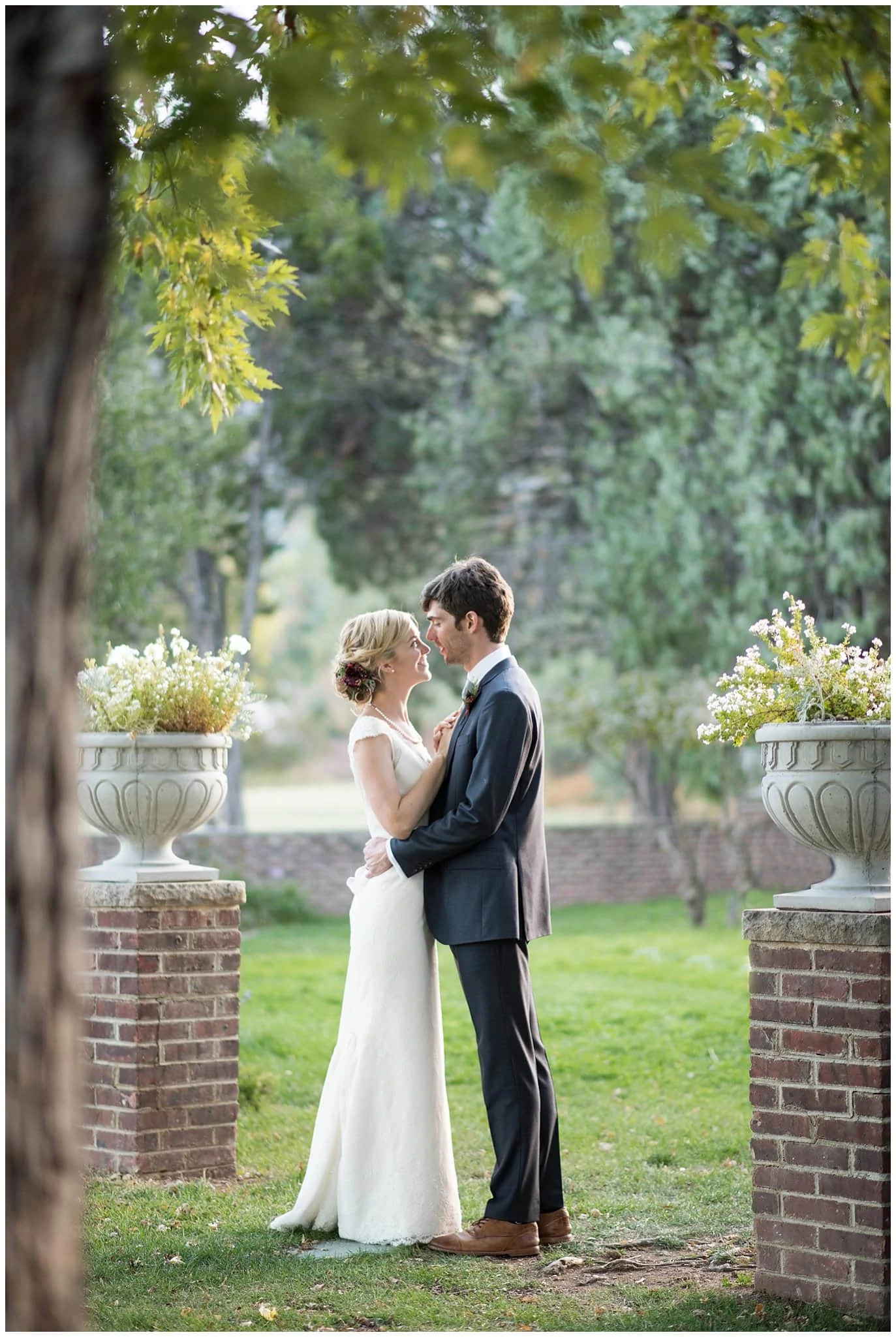 bride and groom on grounds of episcopal colorado church photo