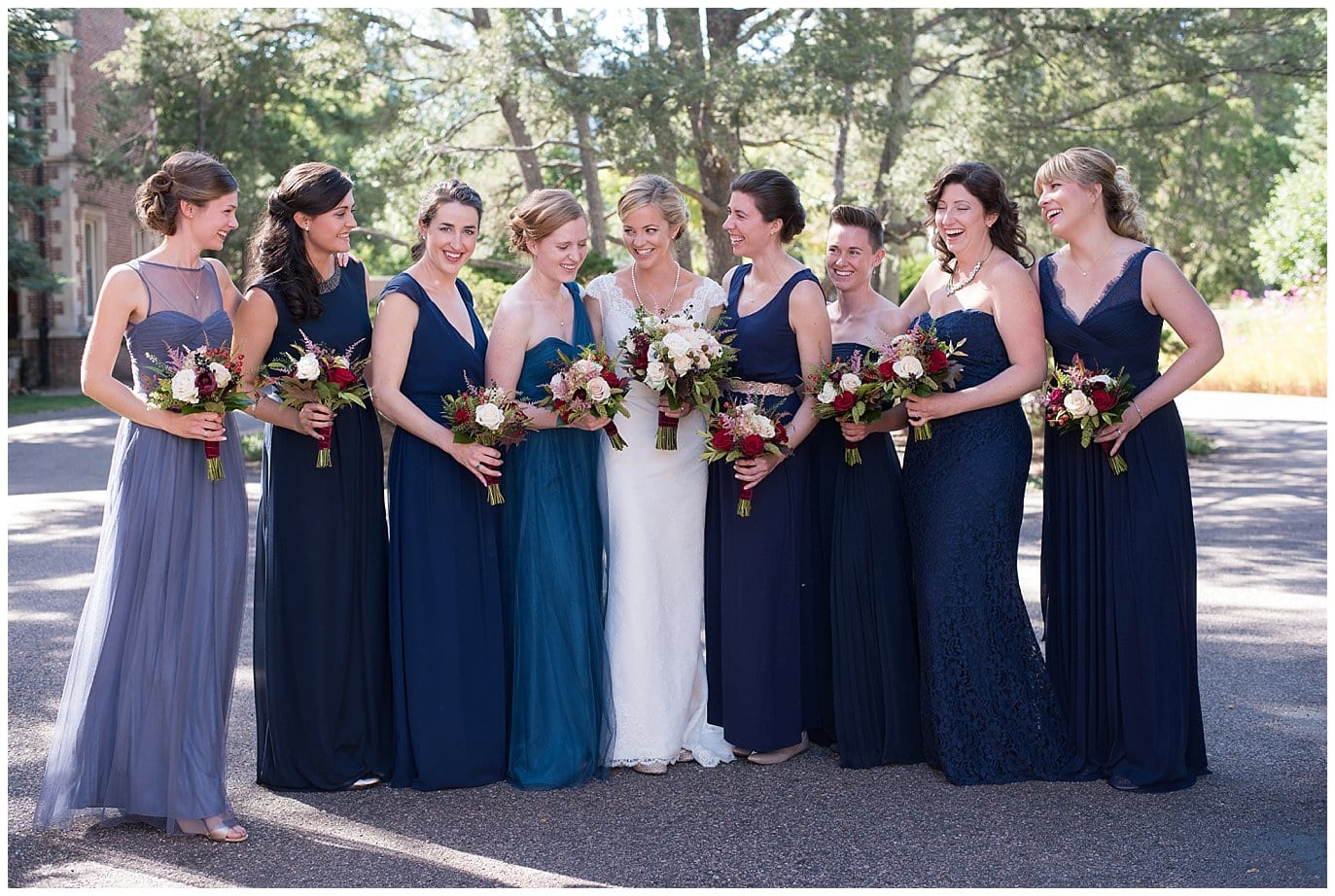 bridesmaids in mismatched navy blue dresses photo