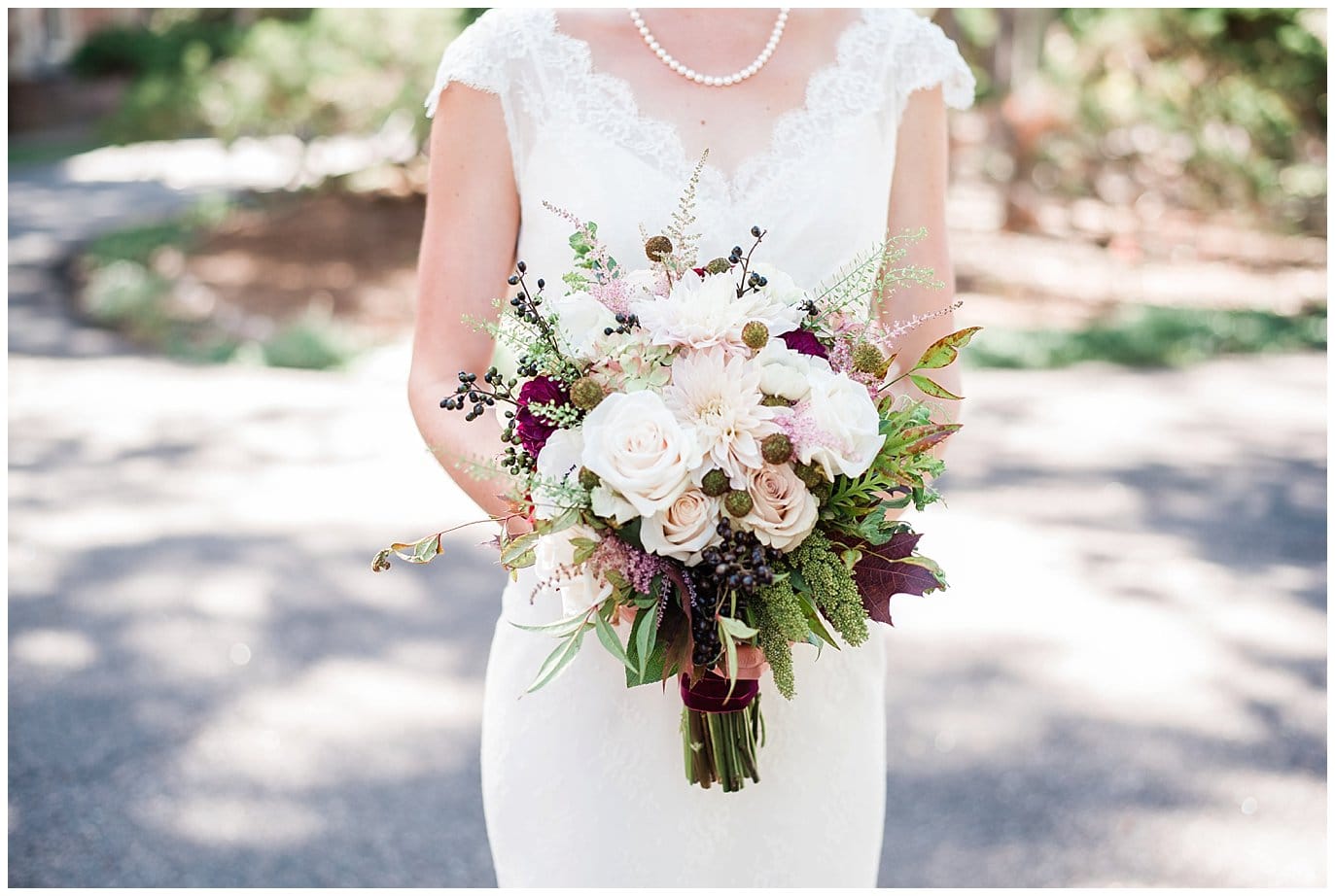 bridal bouquet with roses, dahlias, and berries photo