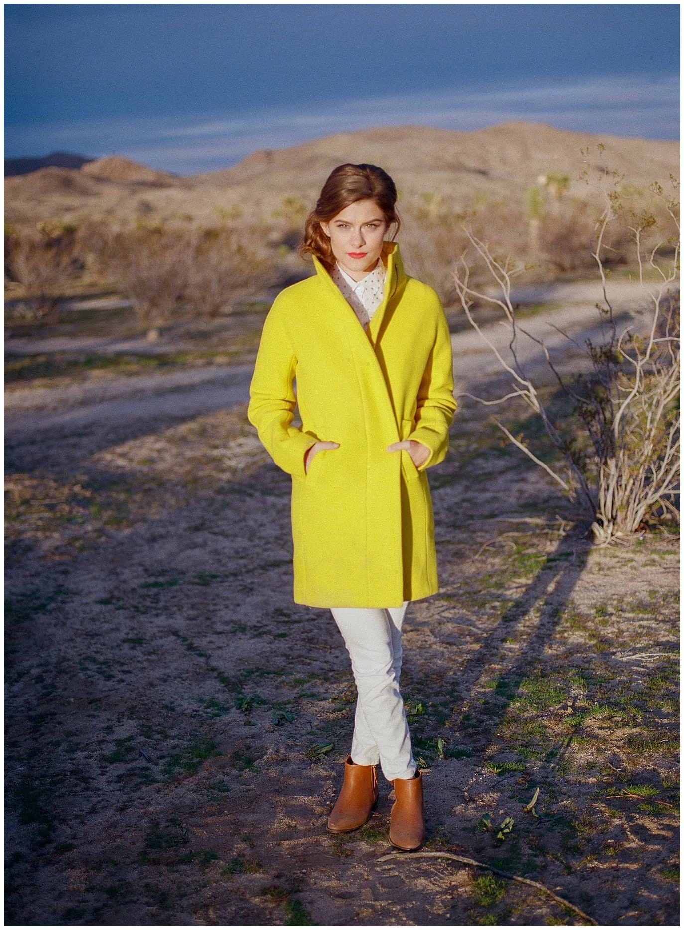 model in yellow coat in California Desert