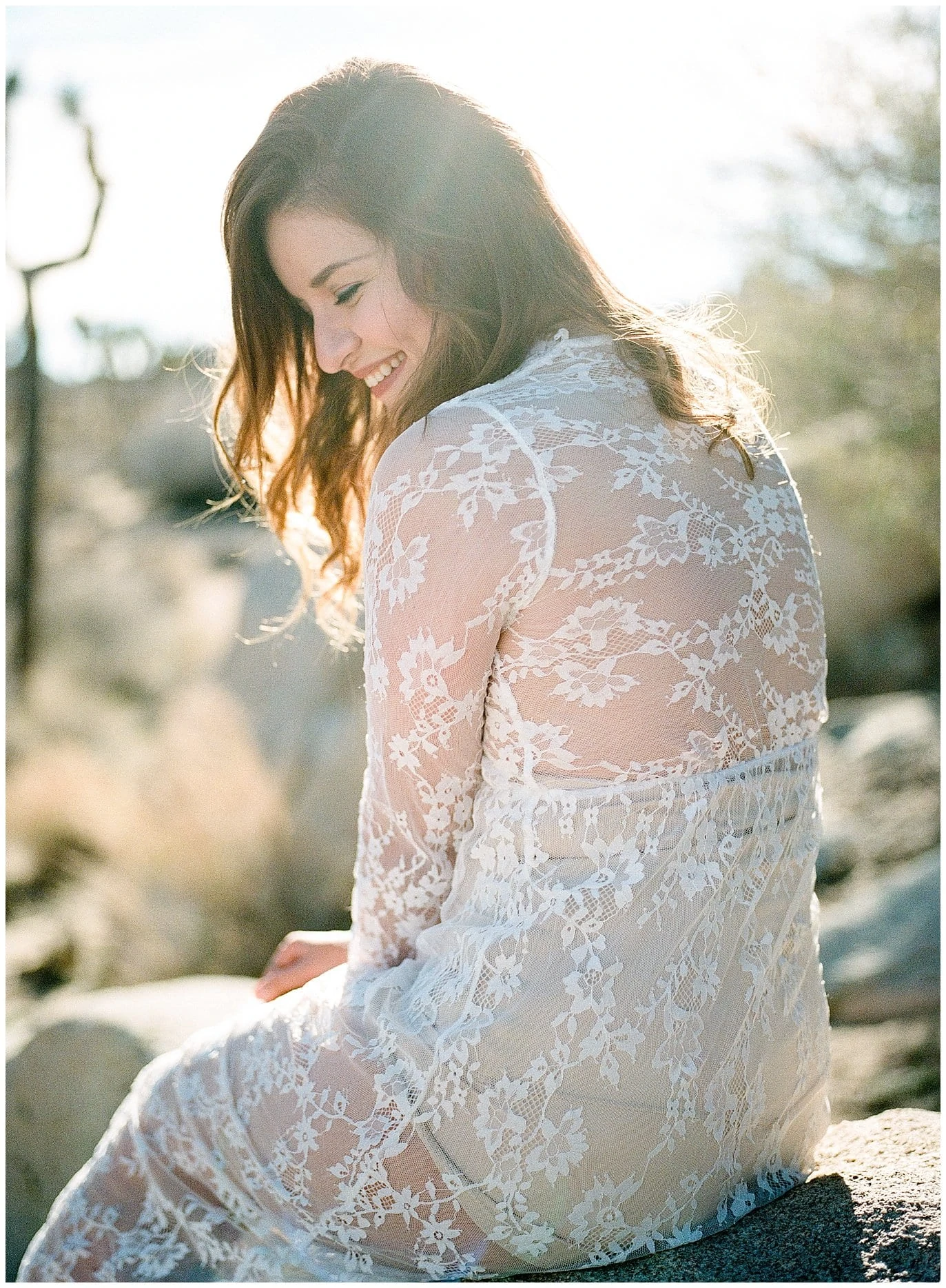 woman laughing in lace dress desert boudoir photo