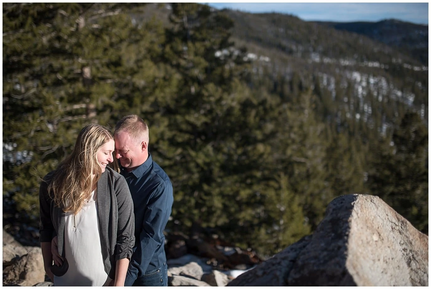 couple in windy colorado mountain engagement photo