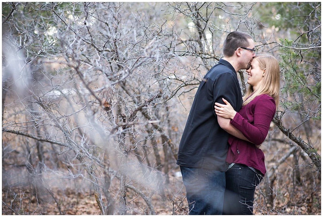 couple cuddling in winter engagement photos