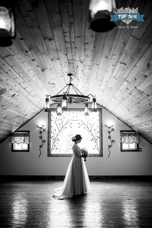 black and white portrait of bride in front of window