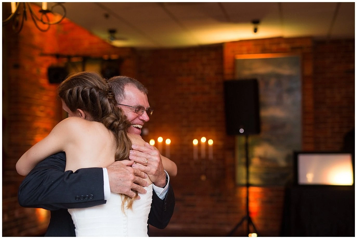 dad hugs daughter during father daughter dance photo