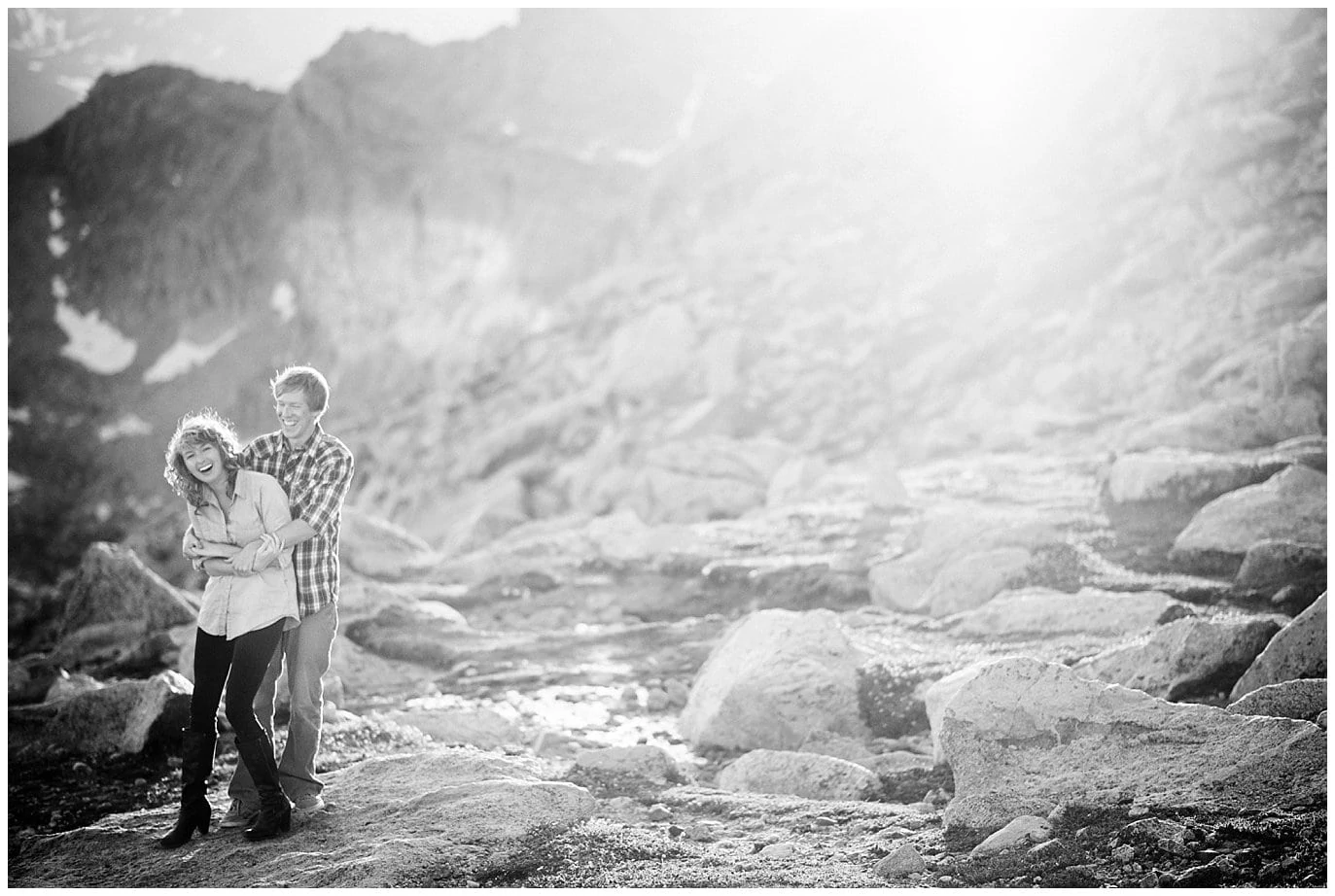 engaged couple laughing in Colorado mountains