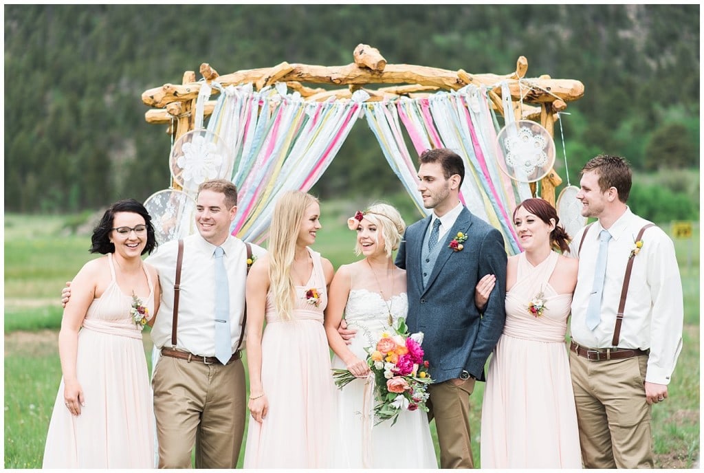 bridal party in front of colorful arch photo