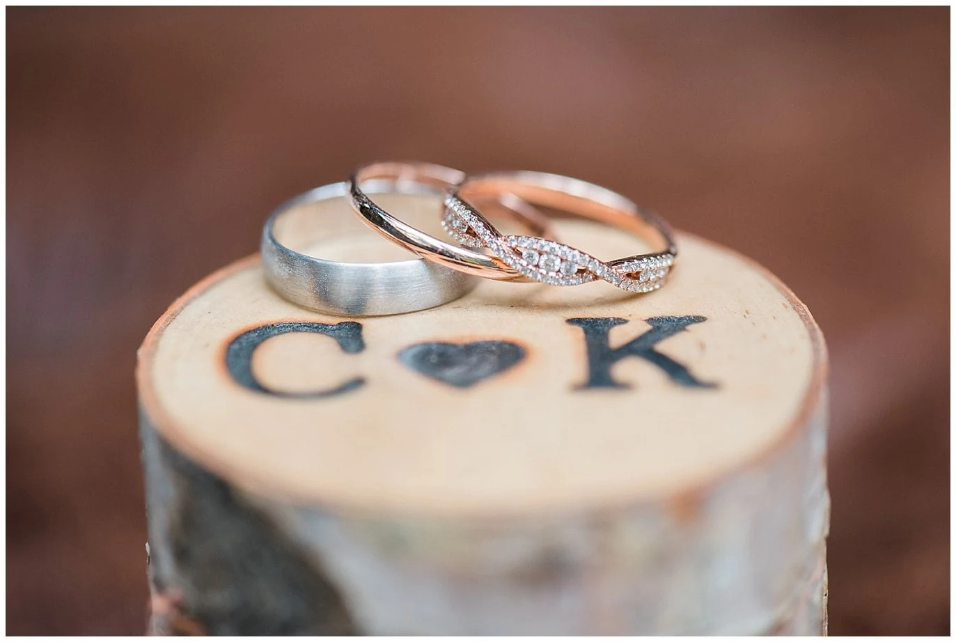 wedding rings on top of wooden engraved box photo