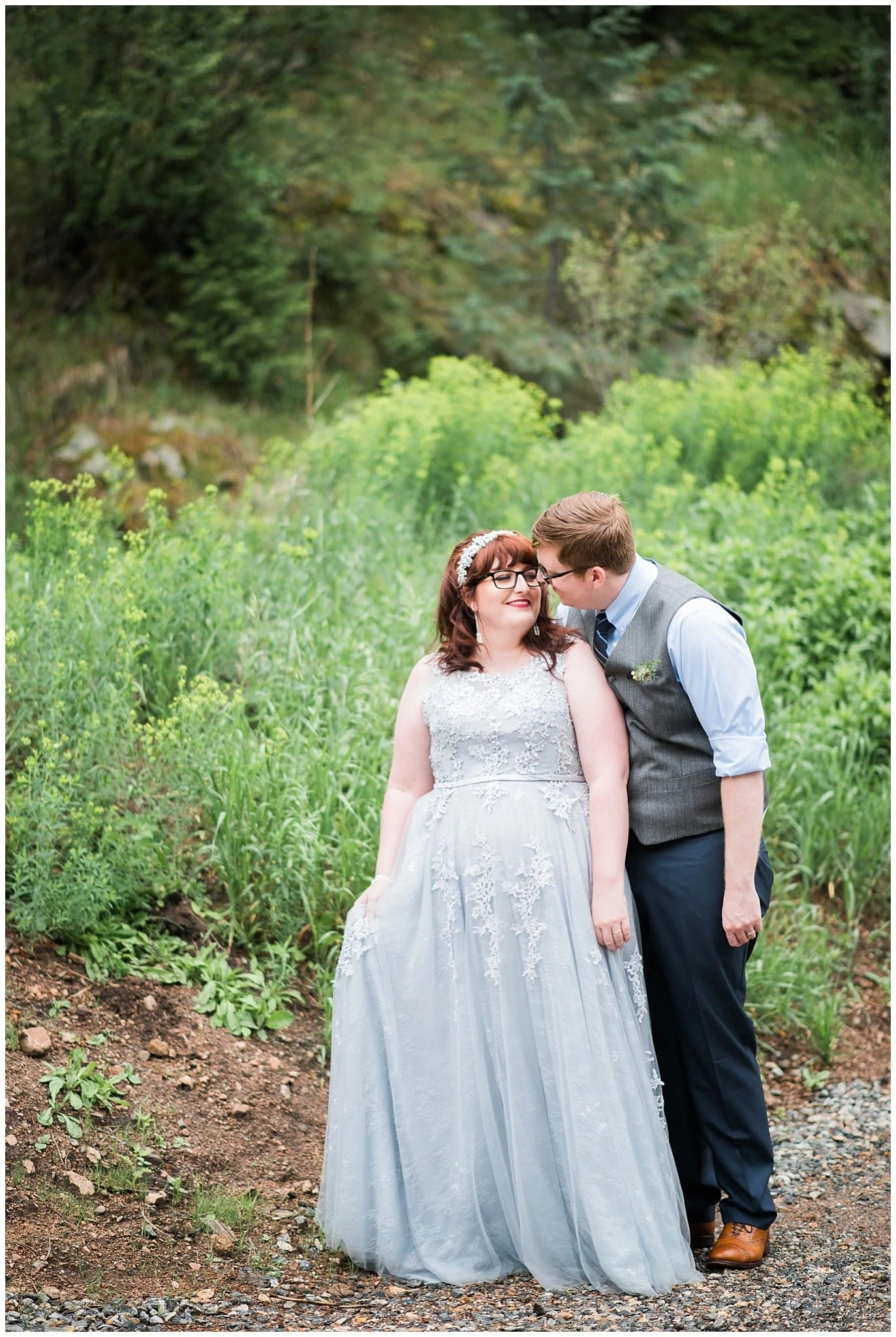 wedding couple in lush evergreen forest photo