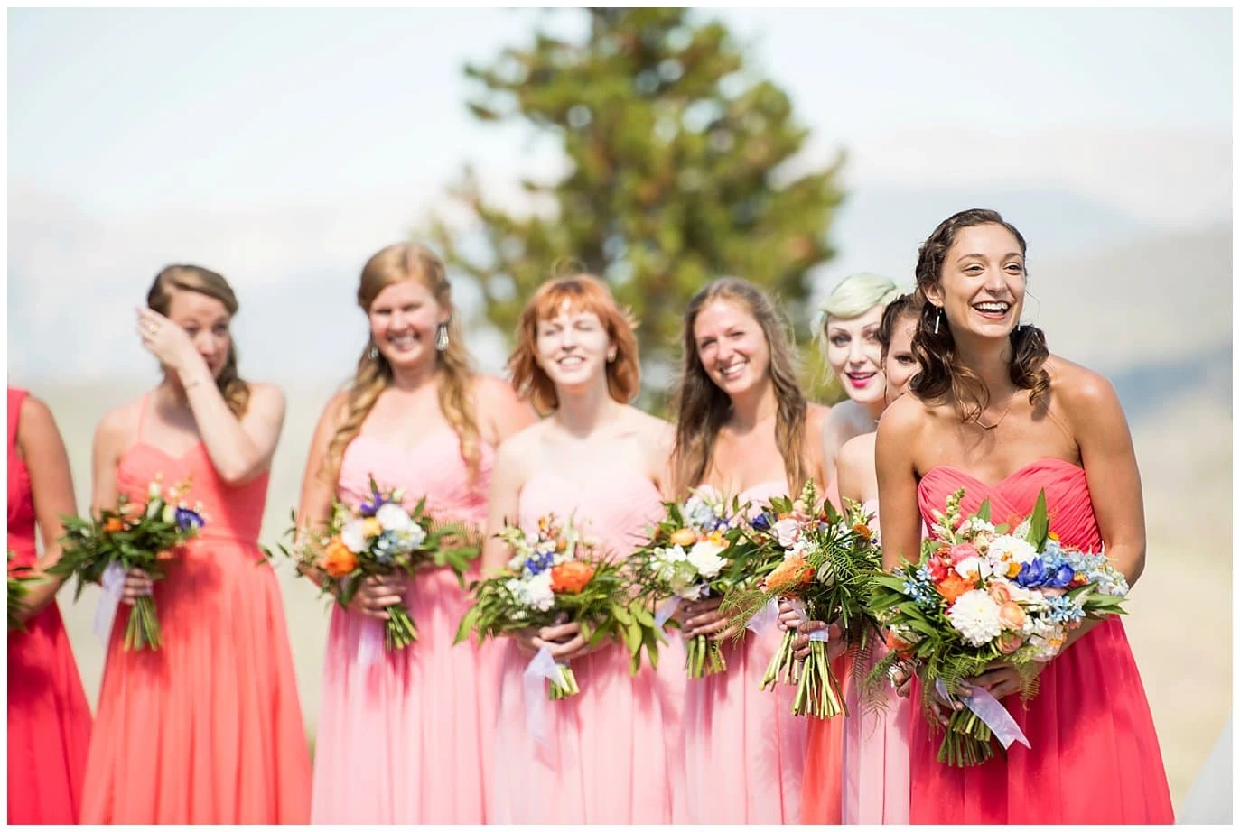 bridesmaids in mismatched coral wedding dresses photo