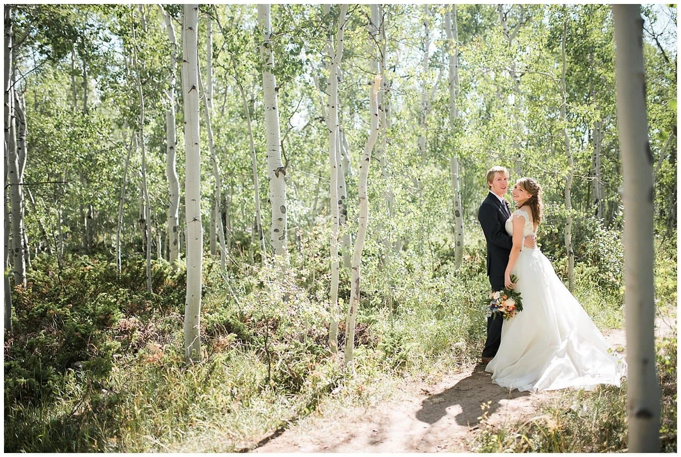 bride and groom in aspens at Granby Ranch photo