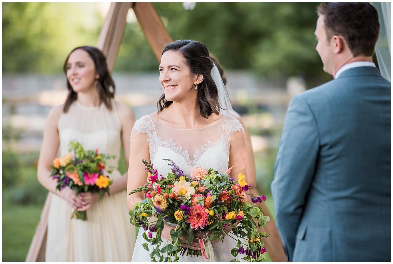 bride with colorful farm fresh bouquet at Lyons Farmette wedding by Boulder Wedding Photographer Jennie Crate