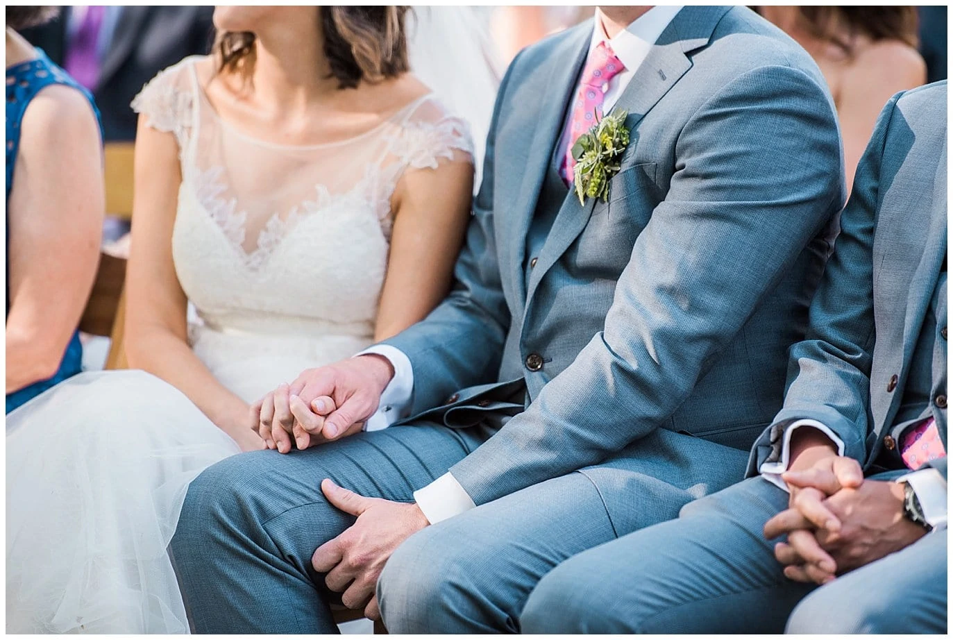 couple holding hands during ceremony at Lyons Farmette wedding by Boulder Wedding Photographer Jennie Crate