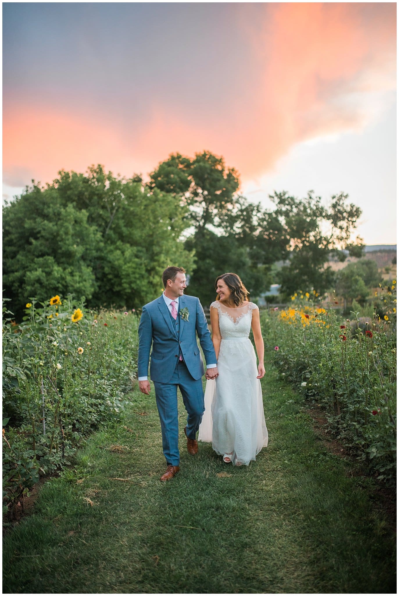 Bride and Groom walking in garden at sunset at Lyons Farmette wedding by Lyons Wedding Photographer Jennie Crate