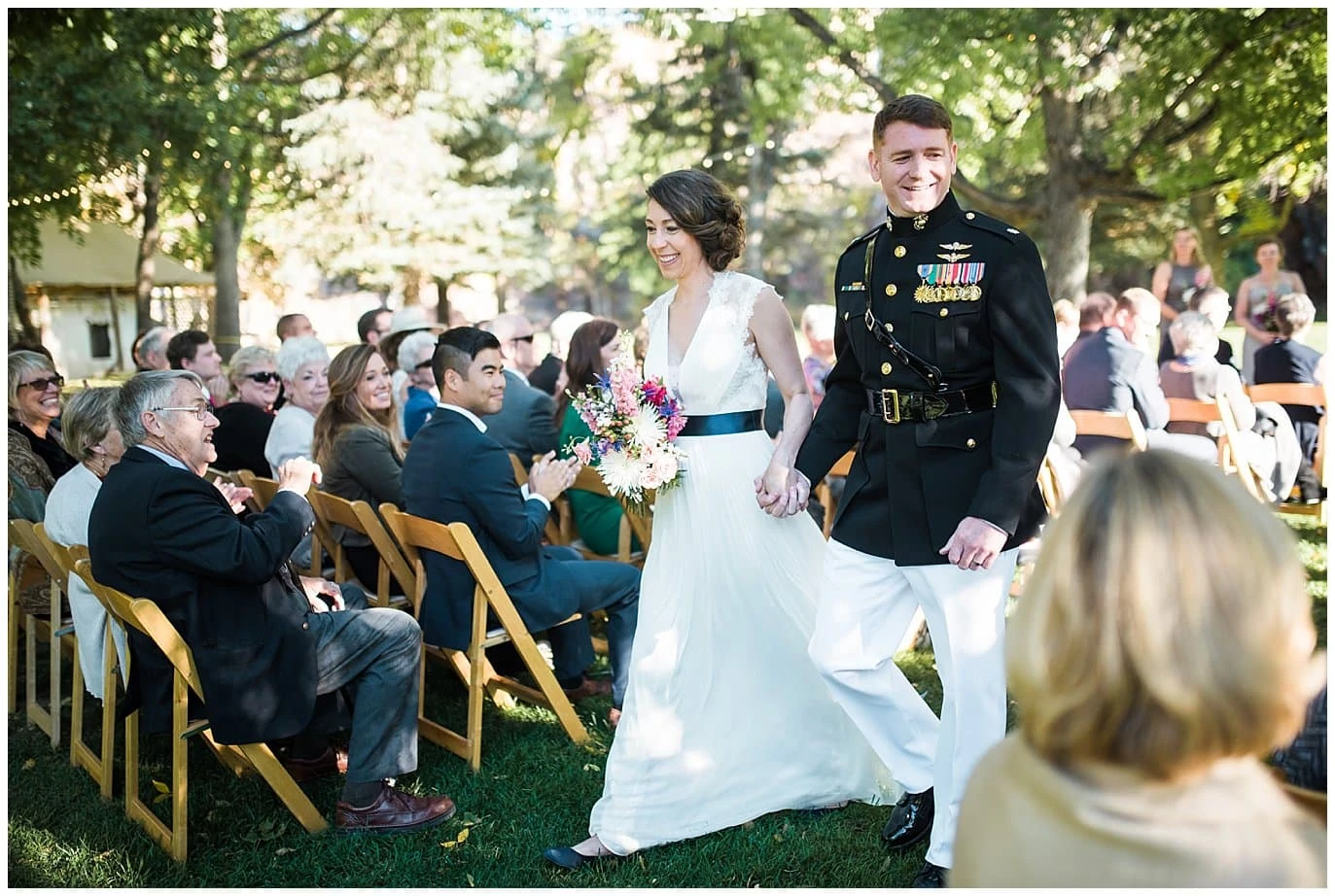 couple walks back down the aisle after outdoor lyons wedding by RMNP Wedding Photographer Jennie Crate