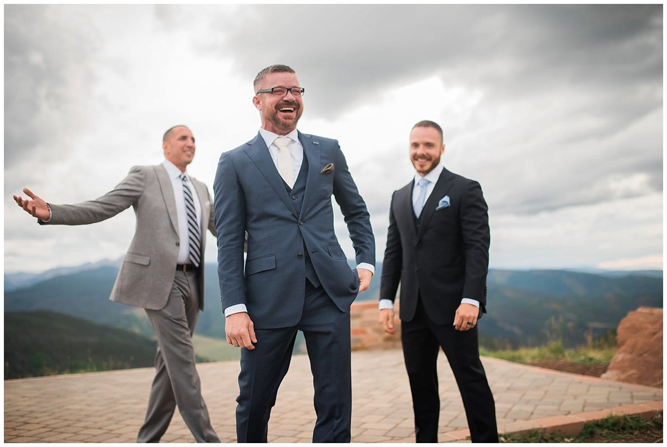 grooms celebrating wedding at top of Vail mountain photo