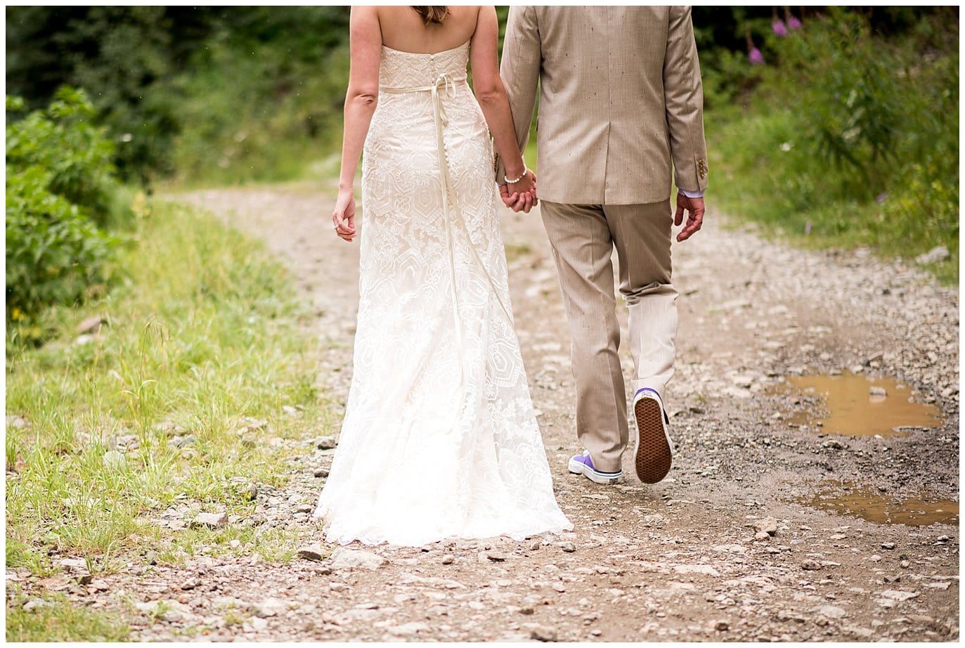 bride and groom walking down road holding hands at Eureka Lodge Wedding by Wildernest Wedding Photographer Jennie Crate
