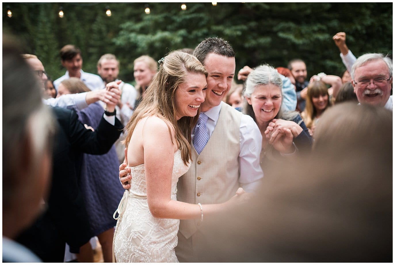 bride and groom dance in circle of friends at Eureka Lodge Wedding by Dillon Wedding Photographer Jennie Crate