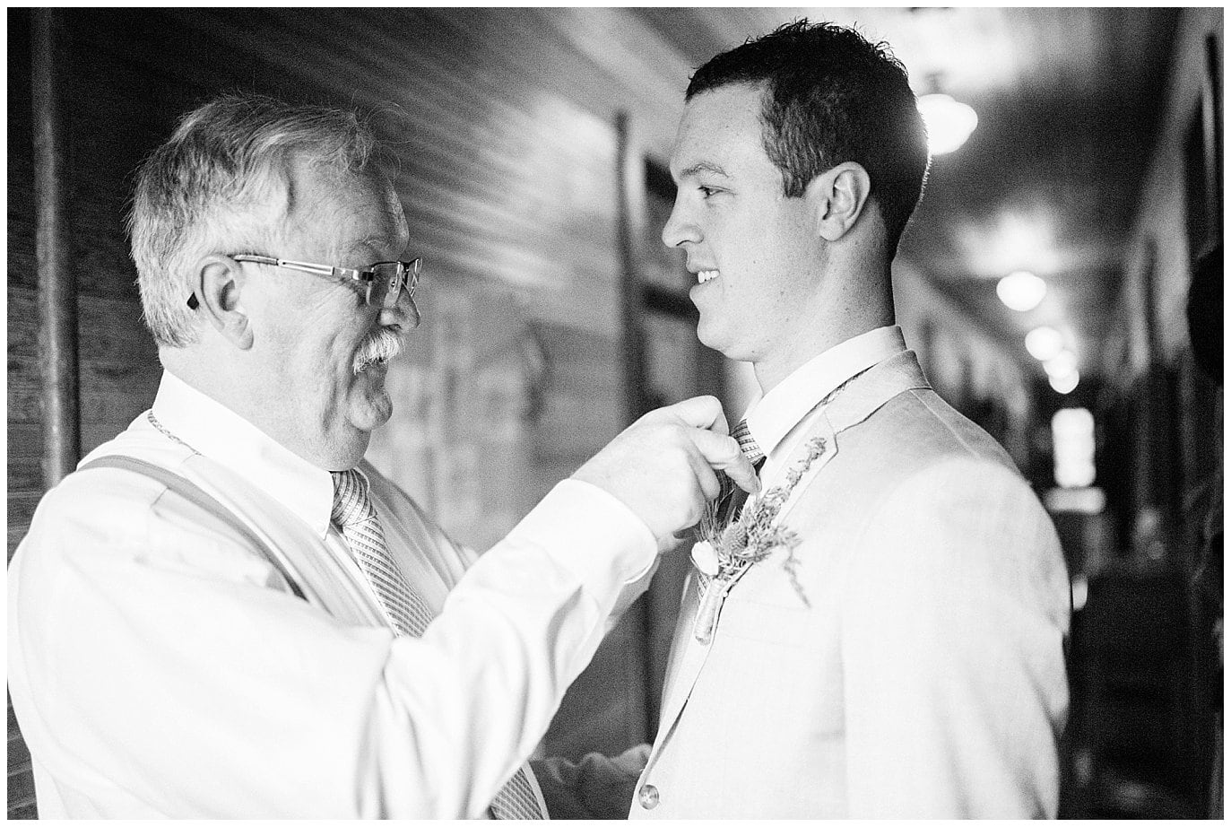 groom's dad putting on tie at Eureka Lodge Wedding by Silverthorne Wedding Photographer Jennie Crate