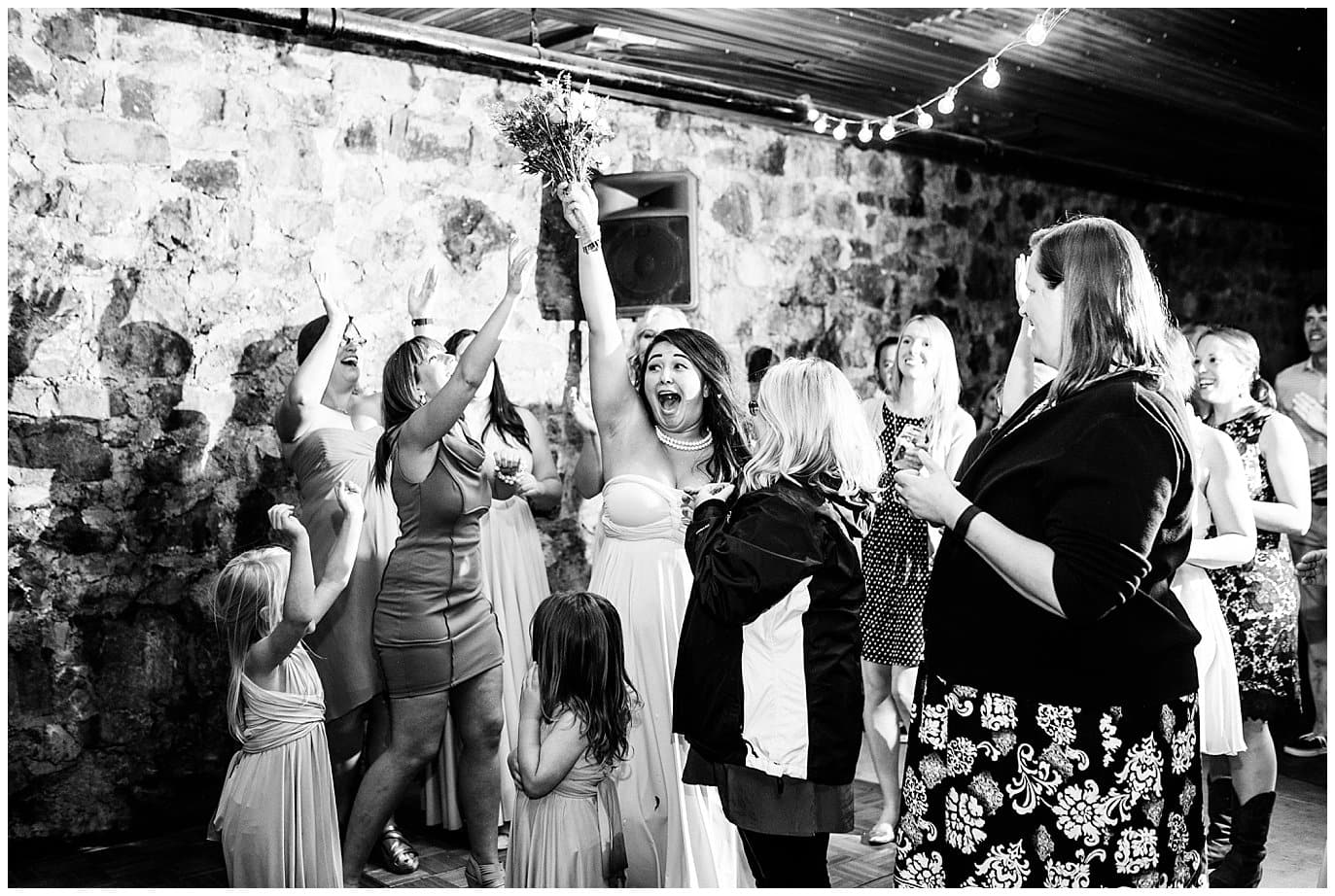 bouquet toss at Eureka Lodge Wedding by Aspen Wedding Photographer Jennie Crate