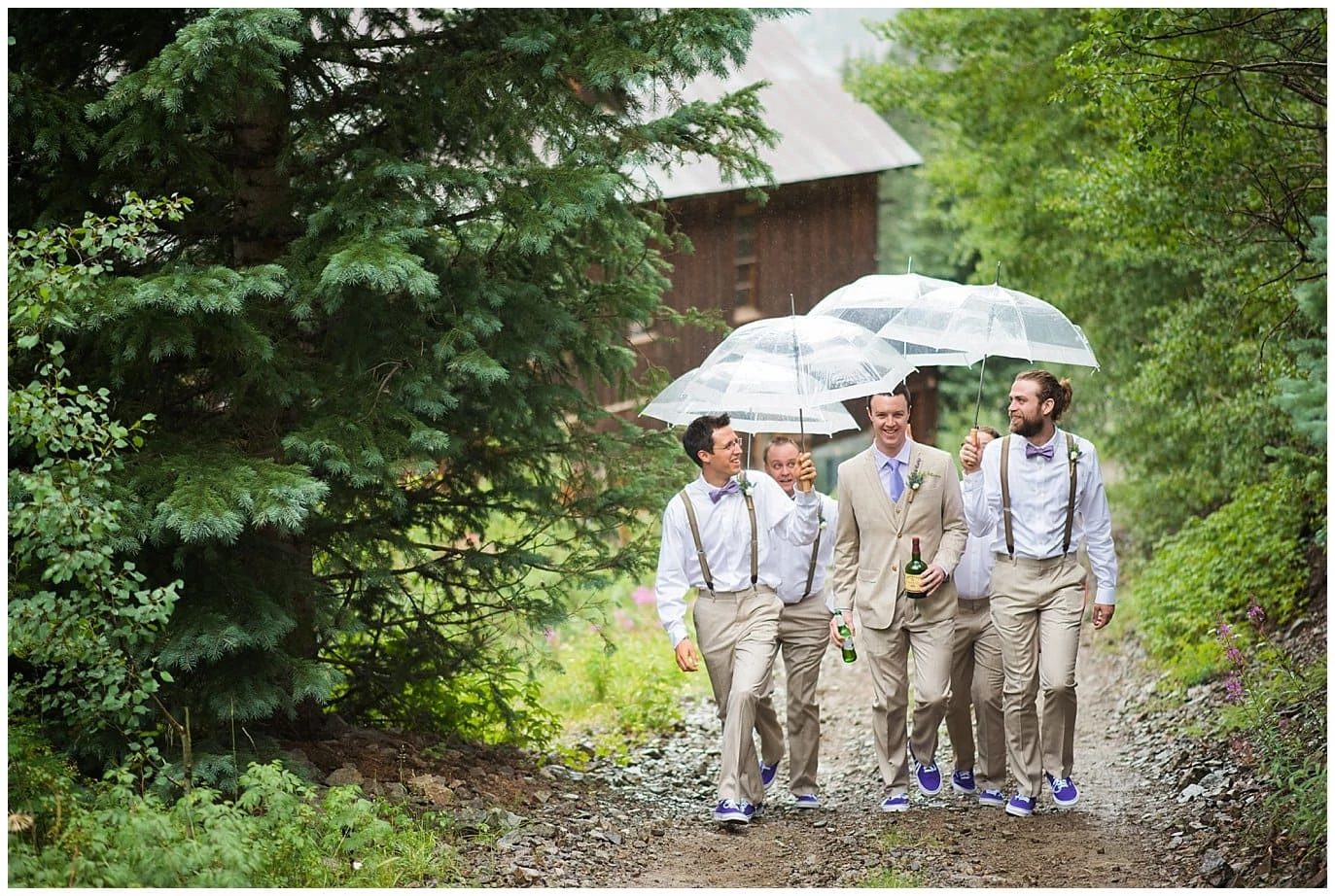 groomsmen walking with umbrellas at Eureka Lodge Wedding by Dillon Wedding Photographer Jennie Crate