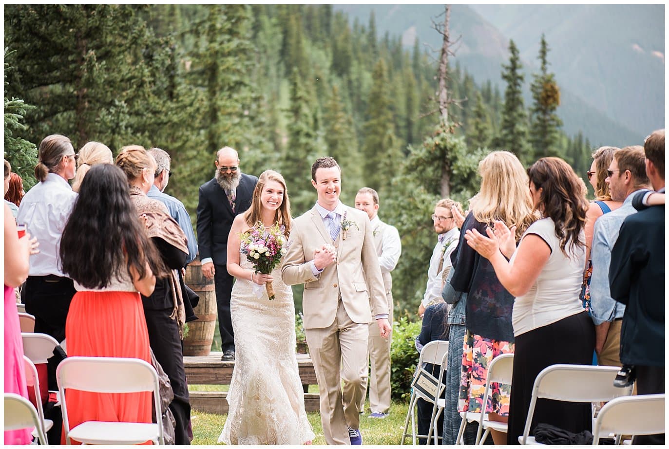 bride and groom walk back up aisle at Eureka Lodge Wedding by Silverthorne Wedding Photographer Jennie Crate