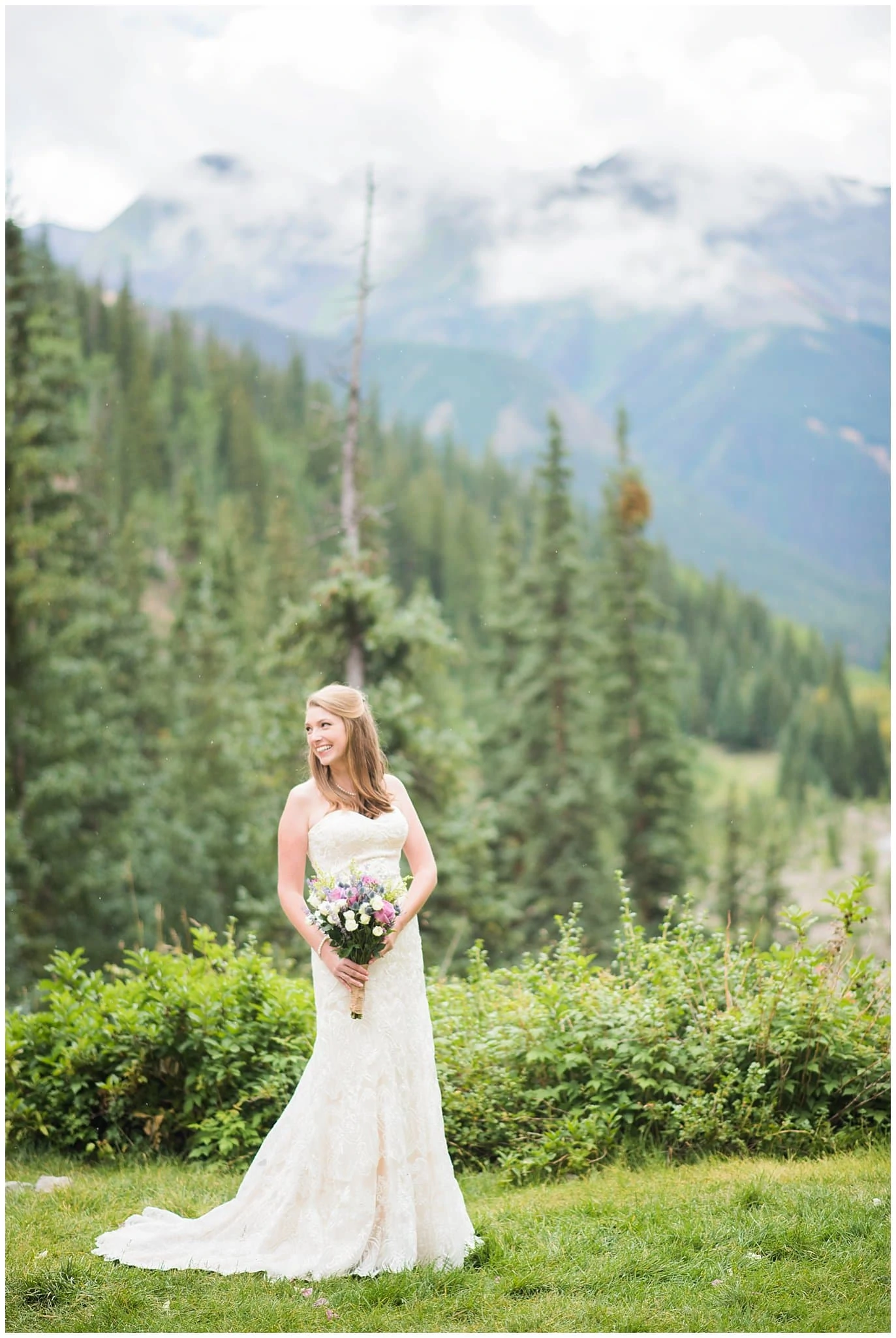 bride in lace dress in evergreen forest at Eureka Lodge Wedding by Aspen Wedding Photographer Jennie Crate