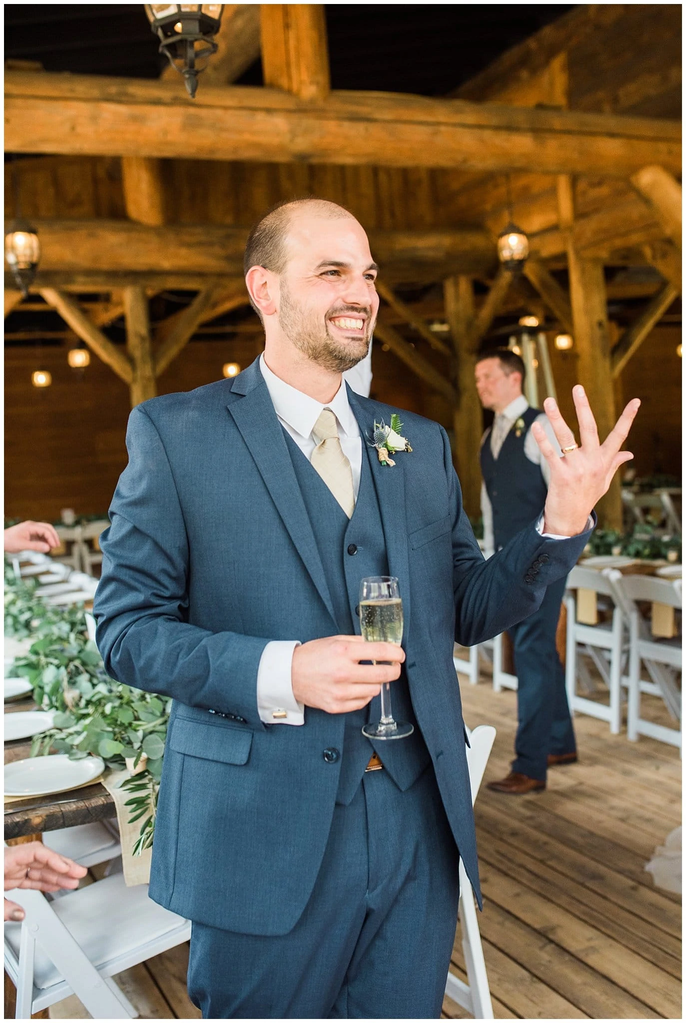 groom in blue suit showing off wedding ring at Piney River Ranch wedding by Aspen wedding photographer Jennie Crate photographer
