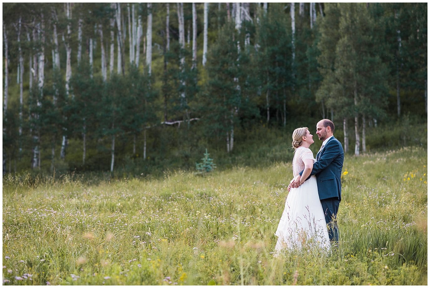 bride and groom in aspens on Colorado mountainside at Piney River Ranch wedding by Aspen wedding photographer Jennie Crate photographer