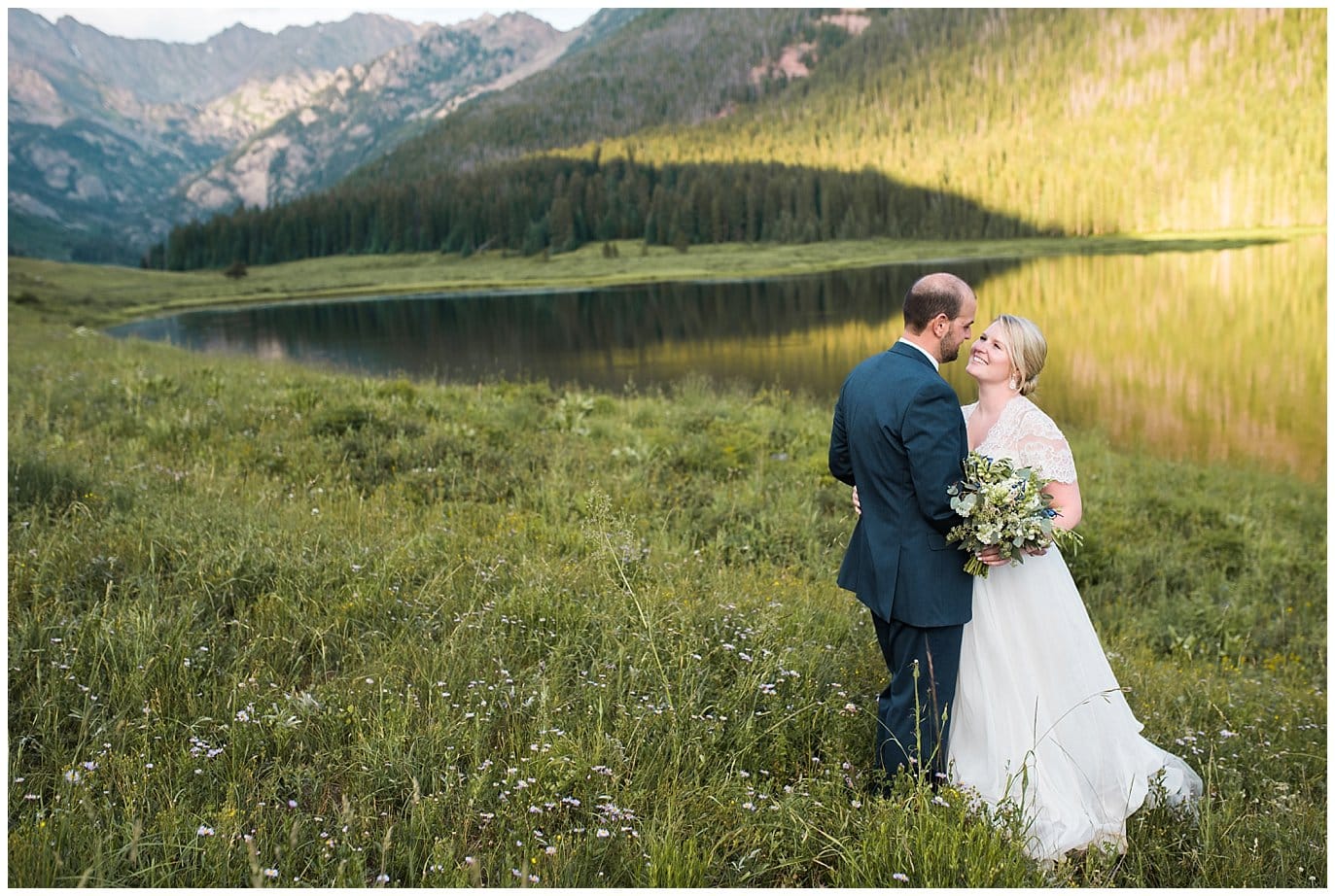 intimate couples portrait by alpine lake in front of mountains at Piney River Ranch wedding by Vail wedding photographer Jennie Crate photographer