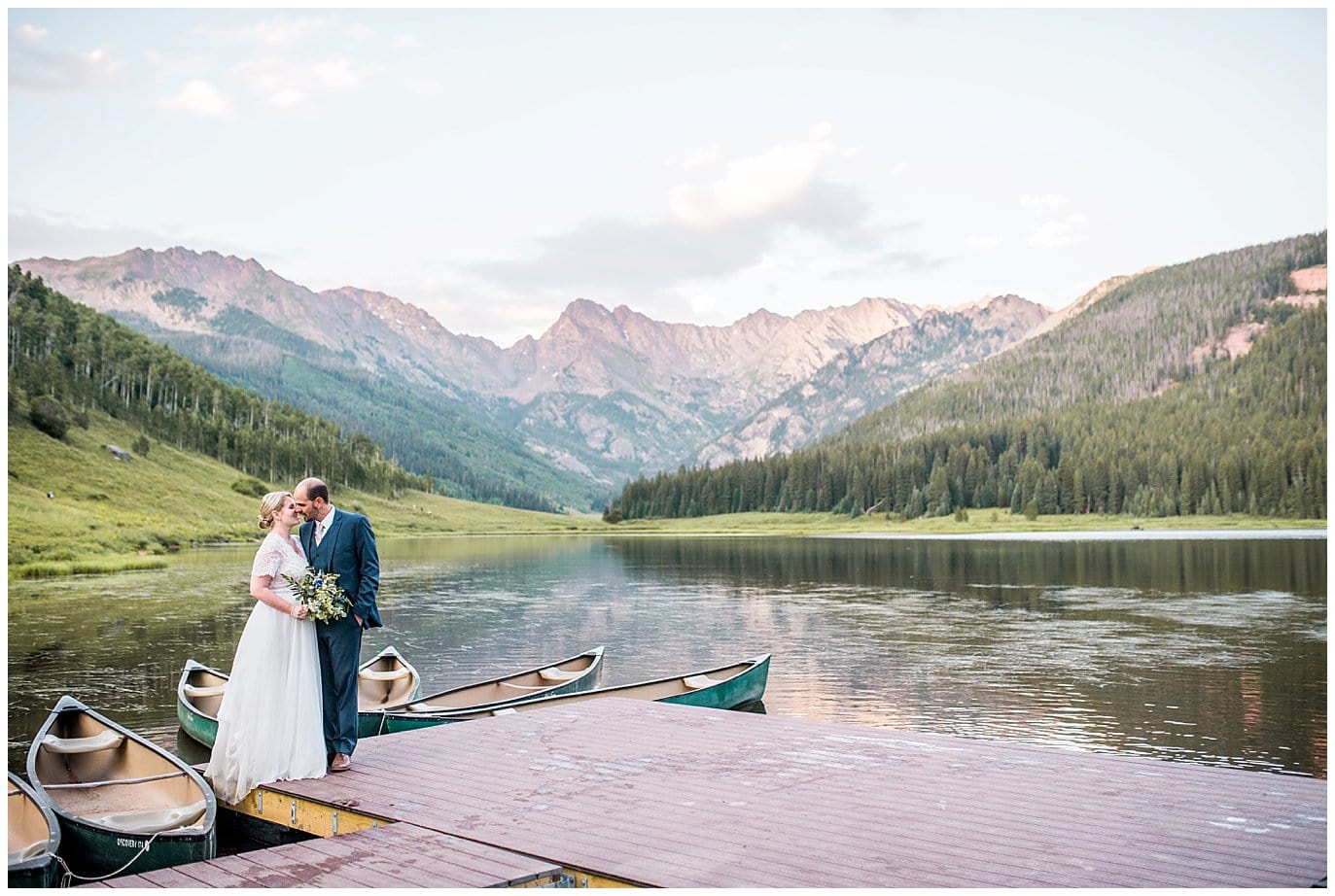 bride and groom on dock at Piney River Ranch wedding by Vail wedding photographer Jennie Crate photographer