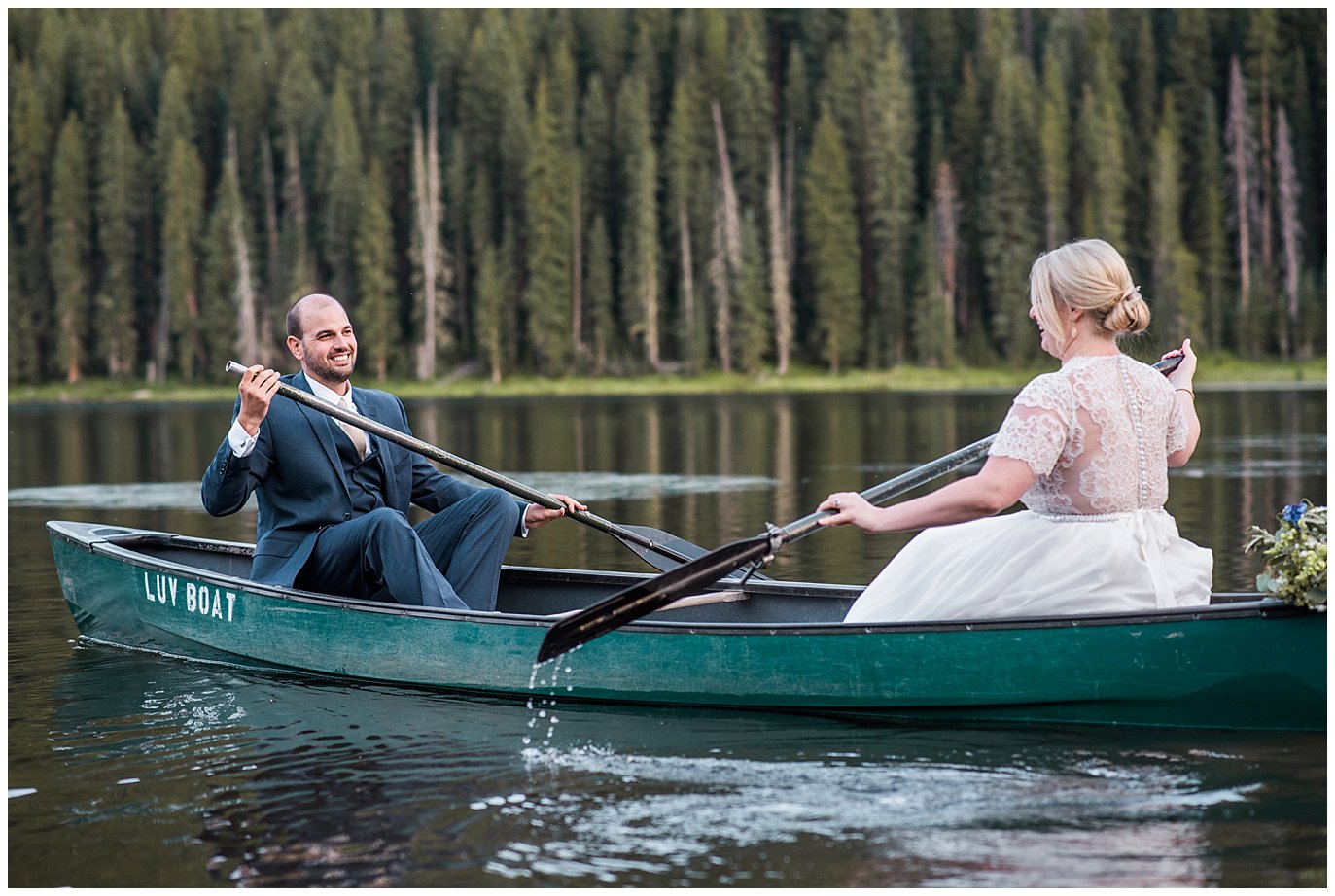 bride and groom rowing canoe on lake at Piney River Ranch wedding by Vail wedding photographer Jennie Crate photographer
