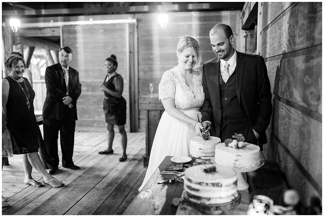 bride and groom cutting cake during colorado mountain wedding reception at Piney River Ranch wedding by Vail wedding photographer Jennie Crate photographer